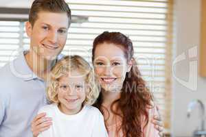 Cheerful family standing in the kitchen