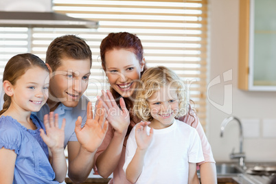 Family waving with their hands