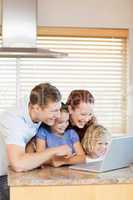 Family exploring the internet in the kitchen