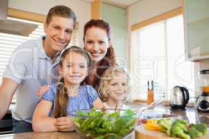 Family standing behind the kitchen counter