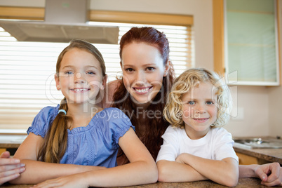 Mother with her children in the kitchen