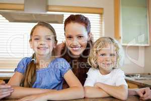 Mother with her children in the kitchen