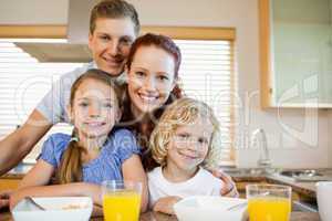 Family with breakfast behind the kitchen counter