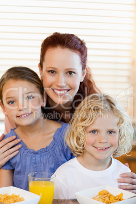 Mother with children and cereals in the kitchen