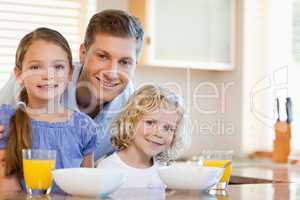 Father with his children in the kitchen