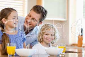 Father with his children behind the kitchen counter