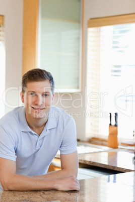 Man leaning against the kitchen counter