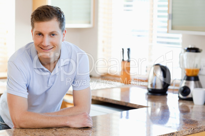 Male leaning against the kitchen counter