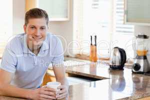 Male leaning against the kitchen counter