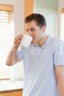 Man drinking some coffee out of his cup