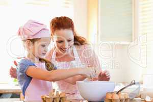 Mother and daughter preparing cookies