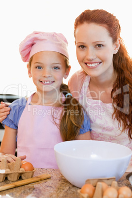 Mother and daughter with ingredients for cookies