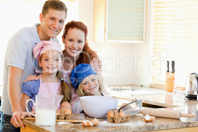 Family with baking ingredients behind the kitchen counter
