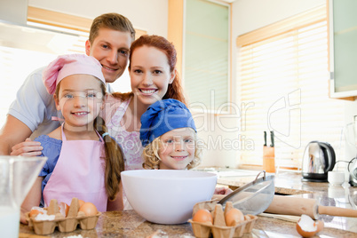 Cheerful family preparing dough