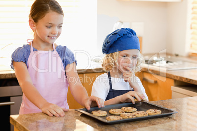 Siblings stealing cookies