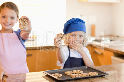 Siblings showing their cookies