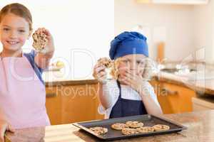 Siblings showing their cookies