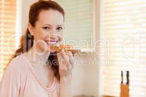 Smiling woman with slice of bread