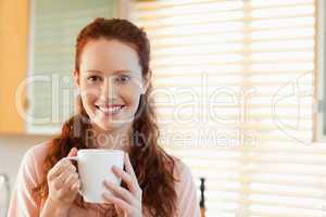 Smiling woman with cup
