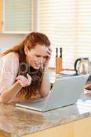 Woman looking annoyed at her laptop