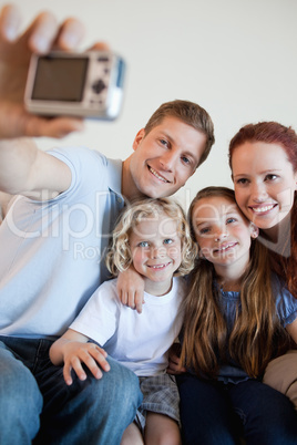 Father taking family picture with digi cam