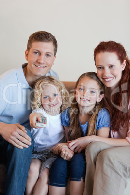 Happy family watching television together