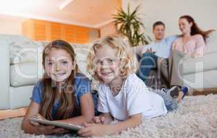 Siblings on the carpet using tablet