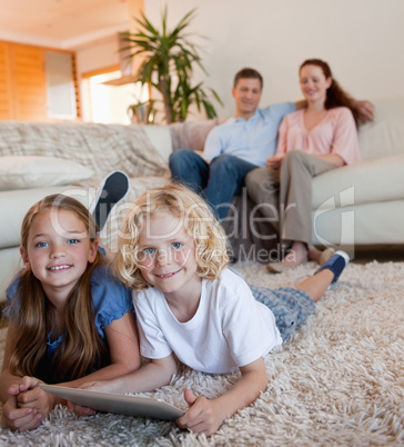 Children on the carpet using tablet