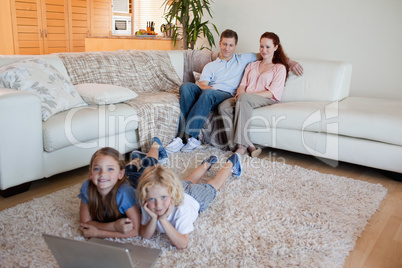 Brother and sister with notebook on the carpet