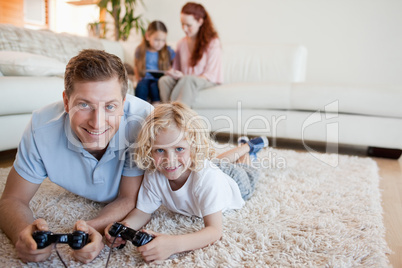 Father and son on the floor playing video games