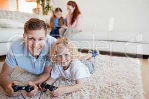 Father and son on the floor playing video games