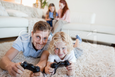 Father and son in the living room playing video games
