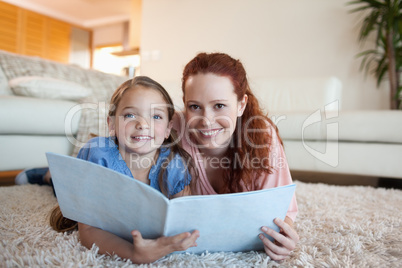 Mother and daughter looking at periodical