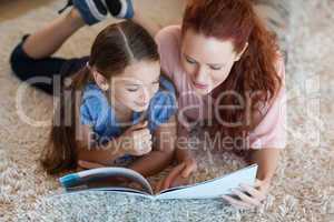 Mother and daughter on the carpet reading