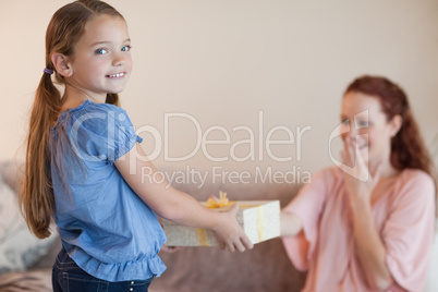 Girl giving her mother a present