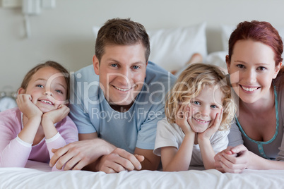 Family lying on the bed