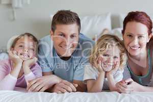 Family lying on the bed
