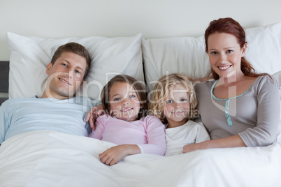 Family sharing the bed