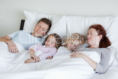 Adorable family snoozing together