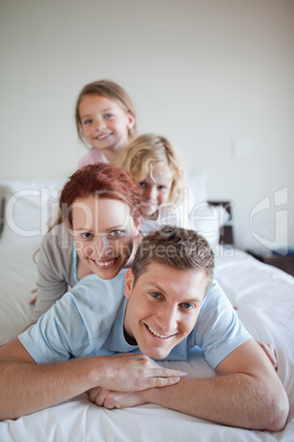 Playful family together on the bed
