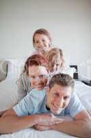 Cheerful family lying on each other