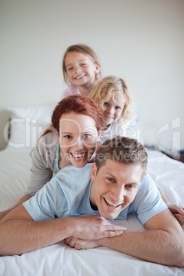 Family having fun on the bed