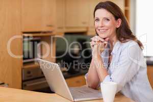 Woman in the kitchen with her laptop