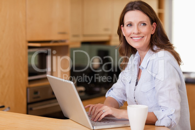 Woman in the kitchen with her notebook