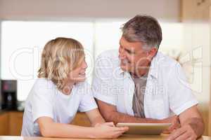 Father and son with tablet