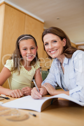 Mother helping daughter with homework