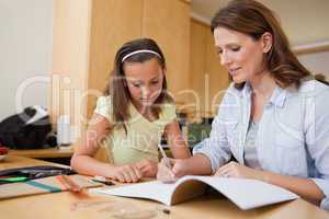 Mother helping daughter with her homework