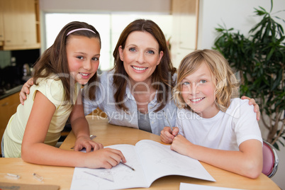 Mother helping her children with homework