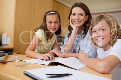 Mother doing homework with children