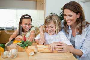 Woman making sandwiches with her children